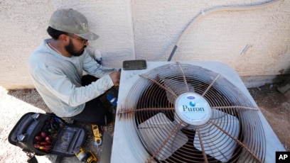 SHOCK PLUNGE Horrifying moment air conditioning engineer bursts into flames as he’s electrocuted and plunges face first on to street